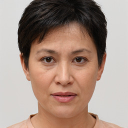 Joyful white adult female with short  brown hair and brown eyes