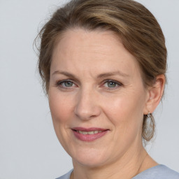 Joyful white adult female with medium  brown hair and grey eyes