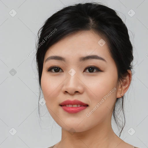 Joyful asian young-adult female with medium  black hair and brown eyes