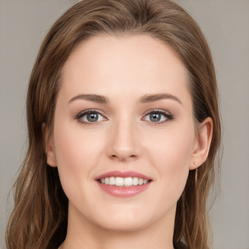 Joyful white young-adult female with long  brown hair and grey eyes