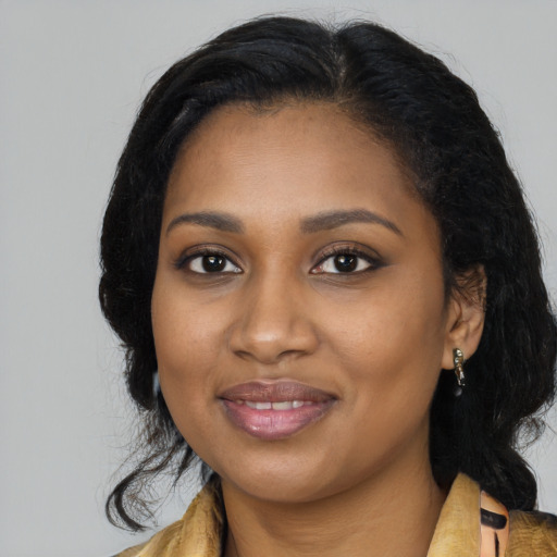 Joyful black young-adult female with long  black hair and brown eyes