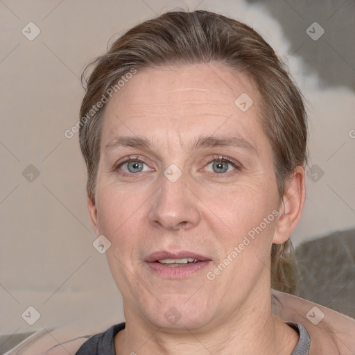 Joyful white adult female with short  brown hair and grey eyes