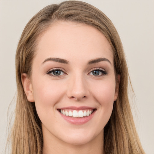 Joyful white young-adult female with long  brown hair and green eyes