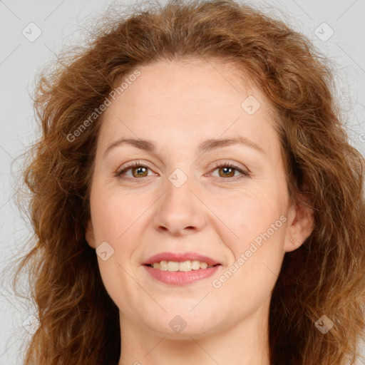 Joyful white adult female with long  brown hair and brown eyes