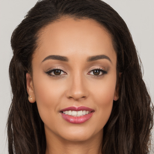 Joyful white young-adult female with long  brown hair and brown eyes