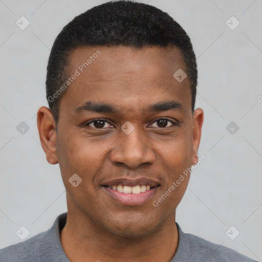 Joyful black young-adult male with short  black hair and brown eyes