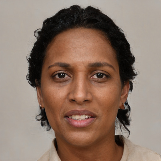 Joyful black adult female with short  brown hair and brown eyes