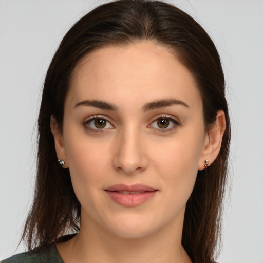 Joyful white young-adult female with long  brown hair and brown eyes