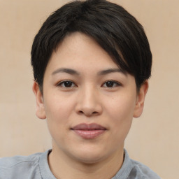 Joyful asian young-adult female with short  black hair and brown eyes