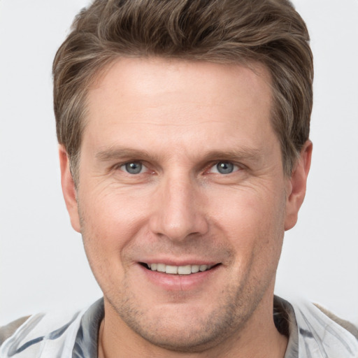 Joyful white adult male with short  brown hair and grey eyes