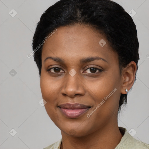 Joyful black young-adult female with short  black hair and brown eyes