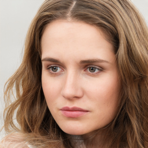 Neutral white young-adult female with long  brown hair and green eyes