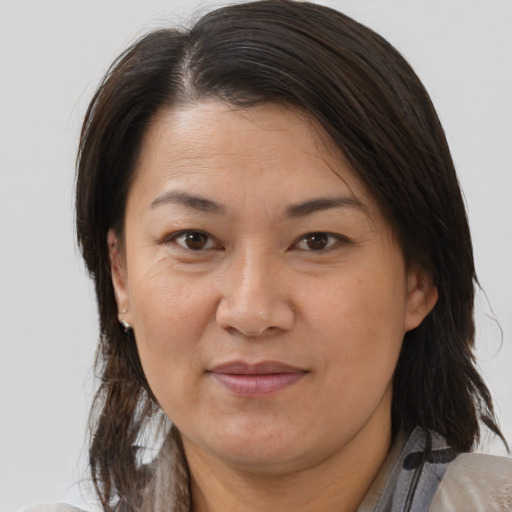 Joyful white adult female with medium  brown hair and brown eyes