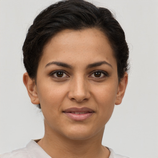 Joyful latino young-adult female with short  brown hair and brown eyes