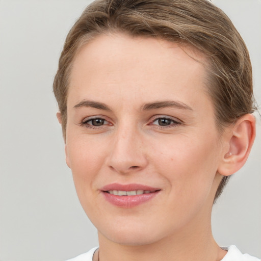 Joyful white young-adult female with short  brown hair and brown eyes