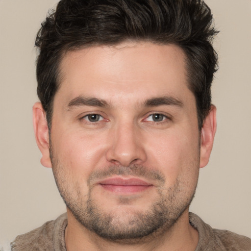 Joyful white adult male with short  brown hair and brown eyes