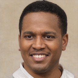 Joyful latino young-adult male with short  brown hair and brown eyes