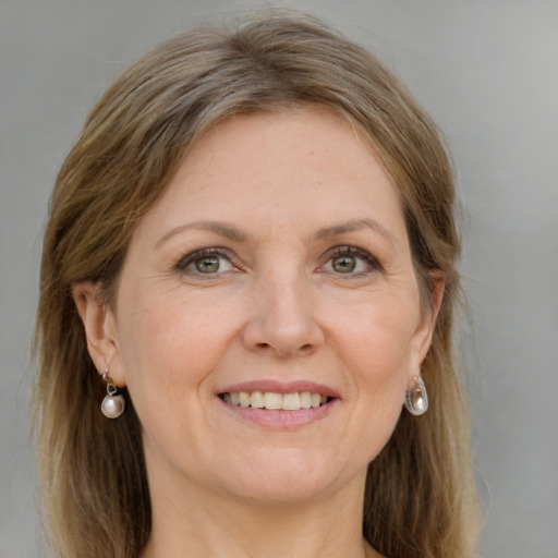 Joyful white adult female with medium  brown hair and grey eyes