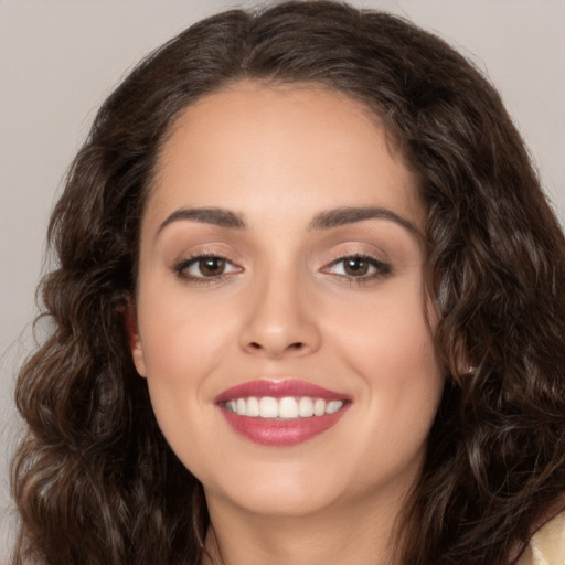 Joyful white young-adult female with long  brown hair and brown eyes