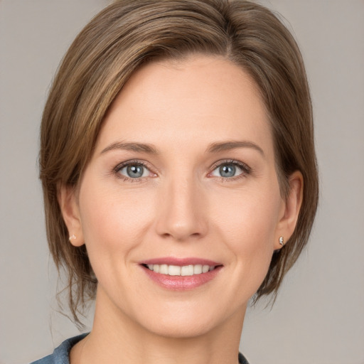 Joyful white young-adult female with medium  brown hair and grey eyes