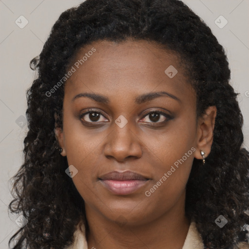 Joyful black young-adult female with long  brown hair and brown eyes