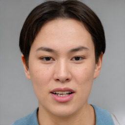 Joyful asian young-adult female with short  brown hair and brown eyes