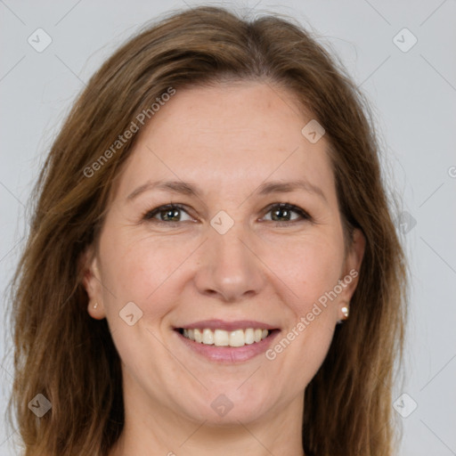 Joyful white adult female with long  brown hair and brown eyes