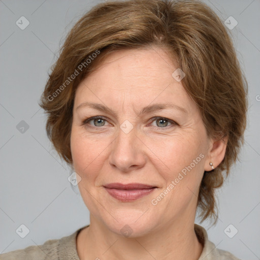 Joyful white adult female with medium  brown hair and grey eyes