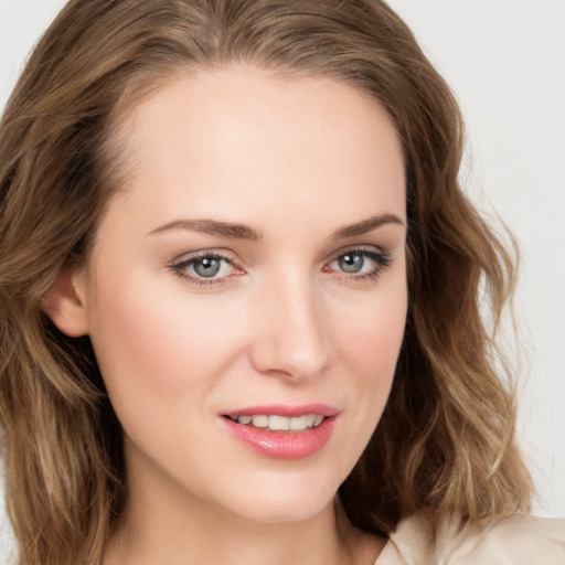 Joyful white young-adult female with long  brown hair and blue eyes