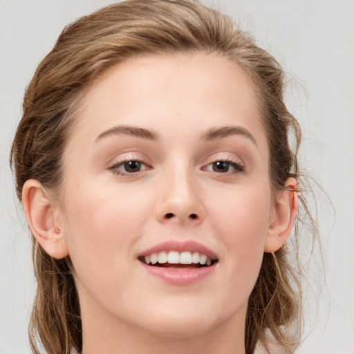 Joyful white young-adult female with long  brown hair and grey eyes