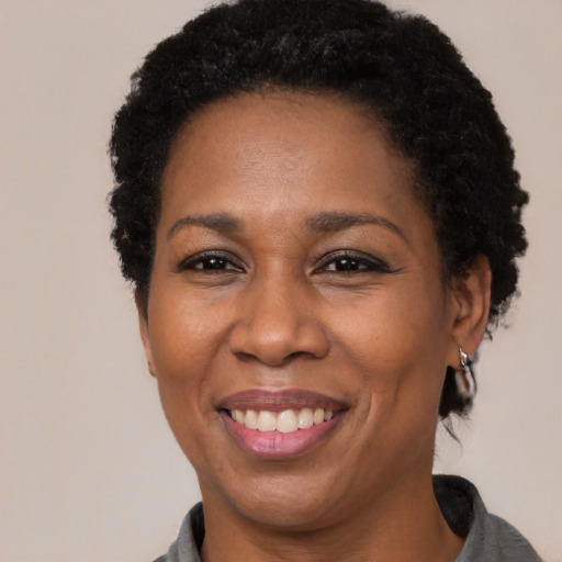 Joyful latino adult female with short  brown hair and brown eyes