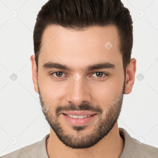 Joyful white young-adult male with short  brown hair and brown eyes