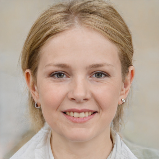 Joyful white young-adult female with medium  brown hair and blue eyes