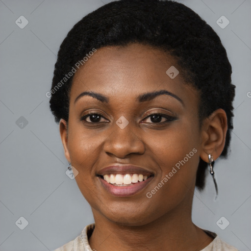 Joyful black young-adult female with short  black hair and brown eyes