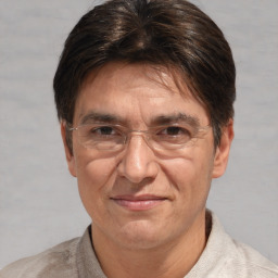 Joyful white middle-aged male with short  brown hair and brown eyes