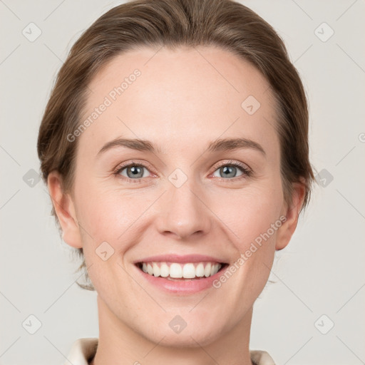 Joyful white young-adult female with short  brown hair and grey eyes