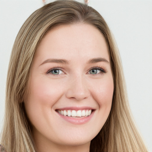 Joyful white young-adult female with long  brown hair and blue eyes