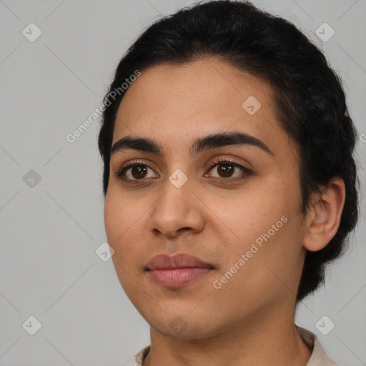 Joyful latino young-adult female with short  black hair and brown eyes