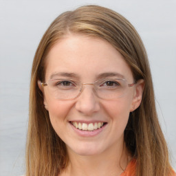 Joyful white young-adult female with long  brown hair and blue eyes