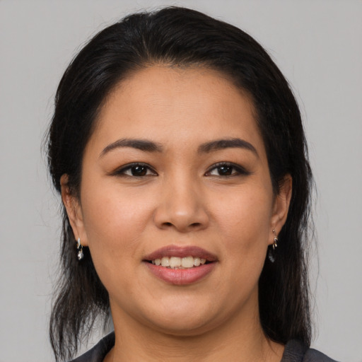 Joyful latino young-adult female with medium  brown hair and brown eyes