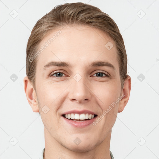 Joyful white young-adult male with short  brown hair and grey eyes