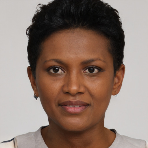 Joyful black young-adult female with short  black hair and brown eyes