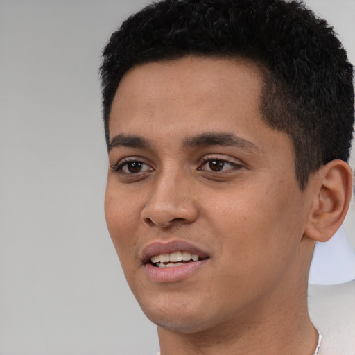Joyful white young-adult male with short  black hair and brown eyes