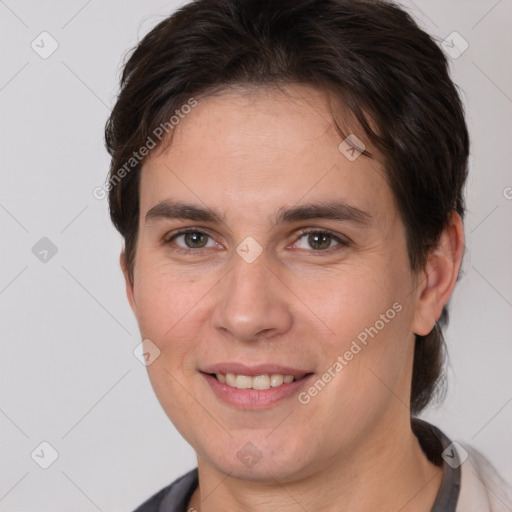 Joyful white young-adult female with short  brown hair and brown eyes