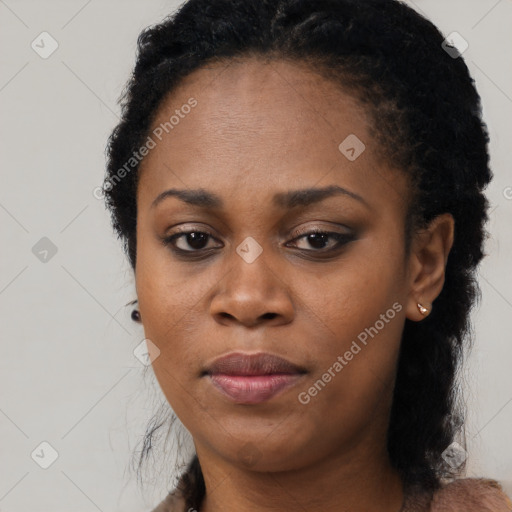 Joyful black young-adult female with long  black hair and brown eyes