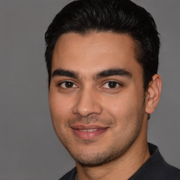 Joyful white young-adult male with short  black hair and brown eyes