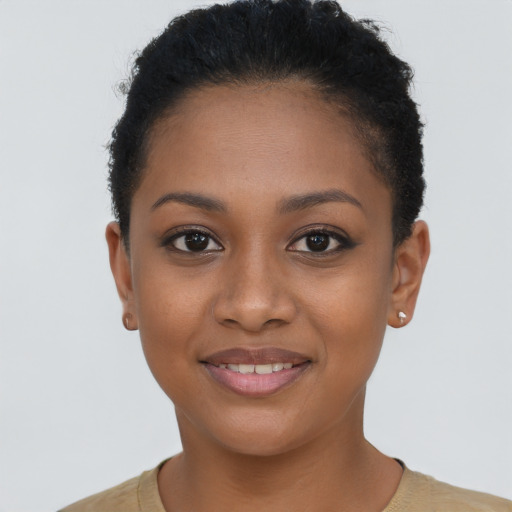 Joyful black young-adult female with short  brown hair and brown eyes