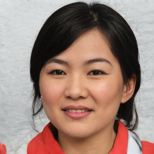 Joyful asian young-adult female with medium  black hair and brown eyes