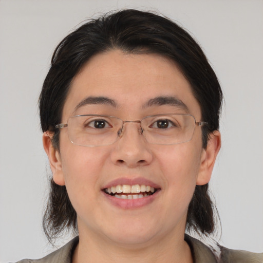 Joyful asian young-adult male with medium  brown hair and brown eyes