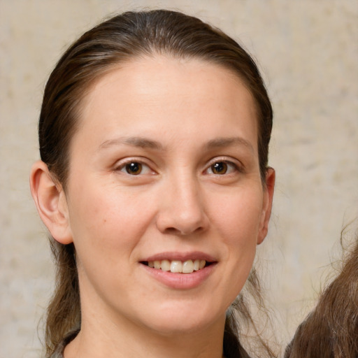 Joyful white young-adult female with medium  brown hair and brown eyes